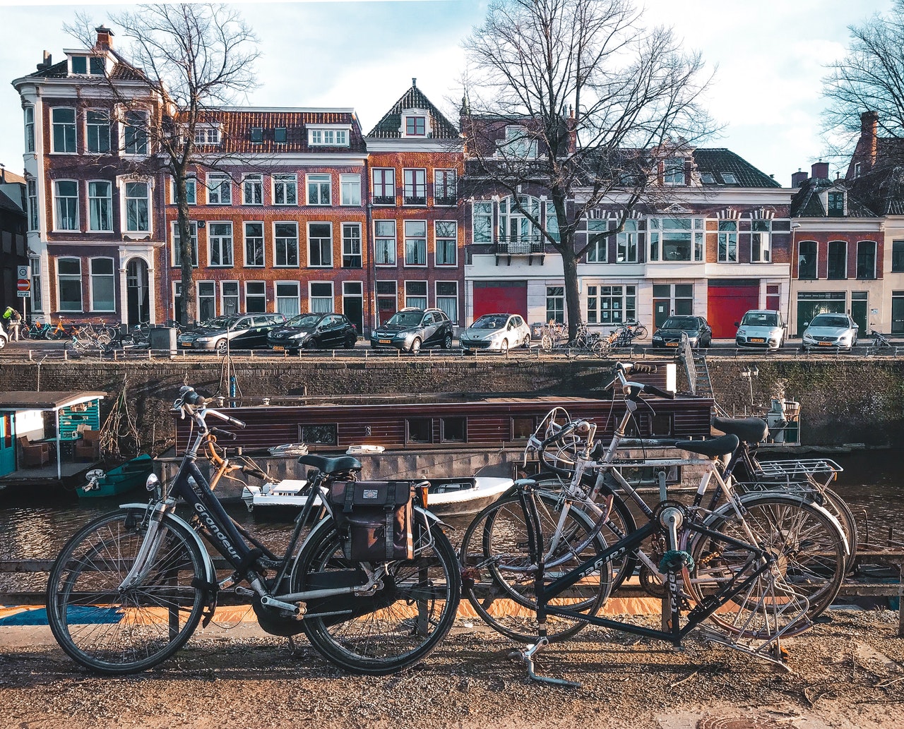 Photo by Kayla Ihrig: https://www.pexels.com/photo/bicycles-parked-beside-brown-wooden-fence-near-a-river-3424845/