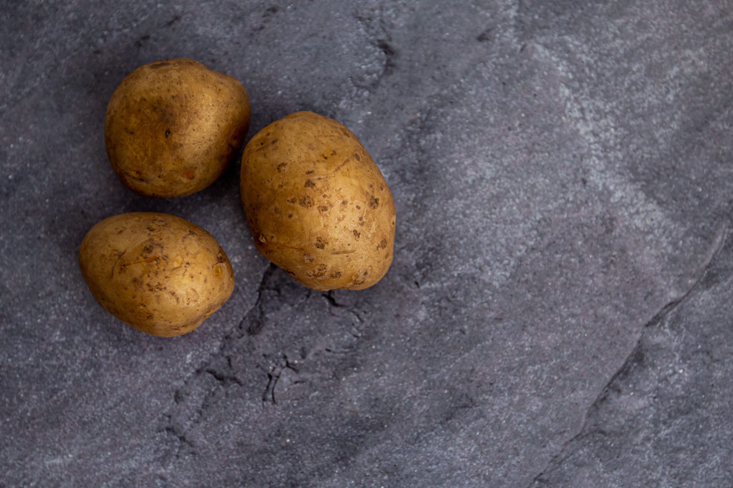 Photo by Victoria Emerson: https://www.pexels.com/photo/whole-uncooked-potatoes-arranged-on-gray-stone-surface-6037886/